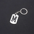 Minimalist stainless steel keychain featuring a silver letter M engraved on a metal tag - Letter M