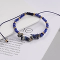 Detail of bohemian woven bracelet with blue beads, gold spacers and natural stone chips - Cyan and Gold