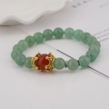 Men's charm bracelet featuring light green tiger eye beads and golden crown centerpiece - Green Aventurine and Red Agate
