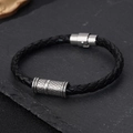Detailed macro view of black braided leather bracelet featuring vintage metal slider charm - Grid-Engraved Cylindrical Slider (BMB-0045)