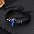 Detail of hand-woven leather Sagittarius bracelet with luminous glass constellation charm - Sagittarius