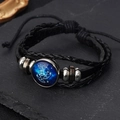 Macro detail of braided leather bracelet featuring a luminous zodiac glass charm and beads - Pisces
