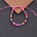 Detail eines verstellbaren Boho-Freundschaftsarmbands mit bunten Regenbogen-Webmustern - Regenbogen/Rosa Seil (10)