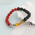 Detail shot of dragon head charms on a volcanic lava and red tiger stone beaded bracelet - Lava Rock & Red Turquoise