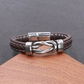 Detail of brown leather braided bracelet with white stitching and magnetic clasp - Brown / Silver Alloy Clasp
