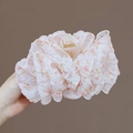 Detail of large floral hair claw clip featuring pink chiffon fabric and golden spring - Pink
