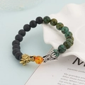 Beaded dragon bracelet with matte black beads and green spotted stones in gold and silver - Black And African Stone