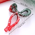 Christmas bow hair claw clip in red and green with snowflake dots and 11cm size guide - Slender Bow Shape (G)