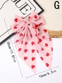 Detailed view of pink bow hair clip with red hearts and long ribbons, measuring 30cm in length - G (Uniform Red Heart)