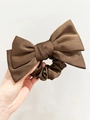 Detail of coffee brown satin hair scrunchie with oversized bow and silky texture - Dark Brown