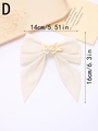 Detailed view of cream velvet bow hair clip with golden butterfly charm and size measurements - Off White