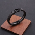 Men's braided leather bracelet with black magnetic infinity clasp on wooden display - Mixed Brown & Black / Alloy Clasp