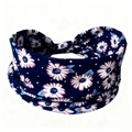 Close-up of navy blue elastic yoga headband with white daisy print and purple details - Navy Blue