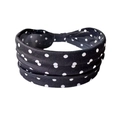 Dettaglio macro della fascia elastica larga a pois bianchi e neri con nodo centrale - Nero