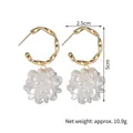 Detailed size view of gold twist hoop earrings with white floral resin charms - Twisted Loop Translucent Petal Dangles (SFLE578)