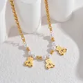 Detail of 18K gold chain necklace with white pearls and three cute bear charms - Bear