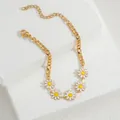 Close-up of golden chain bracelet with five white daisy charms and lobster clasp closure - 五雏菊细链(S-B1090)