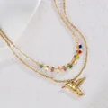 Detail of double-layer gold necklace with colorful beads and small hummingbird pendant - Hummingbird Style / Gold (S-N2193)