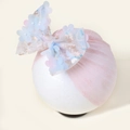 Detailed view of pink mesh baby headband with large sequined floral bow on mannequin - Pink Textured