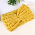 Macro shot of bright yellow knitted headband showing ribbed texture and center twist - Yellow