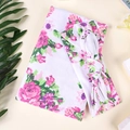 Detailed view of floral baby swaddle blanket and matching headband set on clean background - White