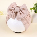 Detail of baby waffle knit turban featuring a large bow and delicate wave embroidery - Khaki (Ribbed)