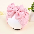 Close-up of pink knit baby headband featuring a large bow and ribbed texture detail - Pink (Ribbed)