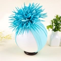 Detailed view of baby turban hat with a large vibrant blue fabric flower decoration - Blue