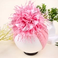 Pink knit baby headband with oversized rhinestone camellia flower and fringed edges - Pink