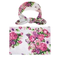 Flat lay of baby swaddle blanket and matching bow headband with pink floral prints - Pink Purple Floral Style (1)