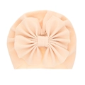Solid apricot baby turban hat with a large bow detail and soft ribbed texture - Creamy White