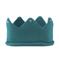 Detailed knit texture of a peacock green baby crown hat with sparkling rhinestone accents - Teal
