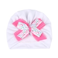 Detail shot of baby turban hat with a double-layered bow featuring colorful heart patterns - White