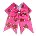 Detail of pink grosgrain ribbon hair bow with brown American football heart pattern - Heart Rugby