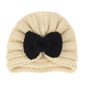 Off-white knitted baby turban hat featuring a large black bow and faux fur pompom decoration - Cream White (Bowknot)
