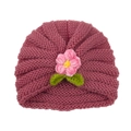 Knitted baby turban hat in dusty pink featuring a crochet flower and green leaves detail - Dust Rose