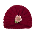 Knitted infant hat in dark red yarn with a 3D floral accent and green leaf detail - Wine Red (Yarn Flower)