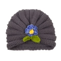 Dark grey knitted baby turban hat with a blue crochet flower and green leaves detail - Gray