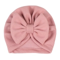 Detail of baby turban hat featuring a large bow and ribbed knit texture in dusty rose - Dusty Pink