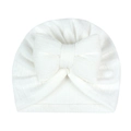 Close-up of white knitted newborn turban hat with a large decorative bow detail - White (Large Bow)