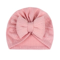 Close-up of pink ribbed baby hat featuring a large oversized stuffed cotton bow detail - Rose Pink (Large Bow)