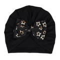 Black cotton infant turban hat featuring a large bow with gold star print design - Black (Star Pattern)