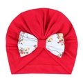 Detail einer roten Baby-Turbanmütze mit großer weißer Schleife und floralem Muster - Rot