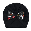 Détail du bonnet turban noir pour bébé avec nœud floral et texture de tricot doux - Noir