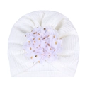 Close-up of white baby turban hat with large gold-spotted tulle flower detail - White