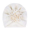 Detail of white newborn turban hat with ribbed texture and gold-dotted 3D flower - Off White