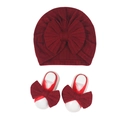 Detail of burgundy newborn turban hat and matching bow foot straps with herringbone knit texture - Red