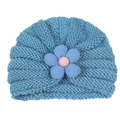 Detailed knit texture of baby turban hat featuring a blue velvet 3D flower and pink core - Blue