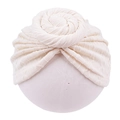 Close-up of cream knit baby turban hat with a donut knot and waffle texture fabric - Beige