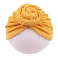 Detailed close-up of a bright yellow knitted baby turban hat with a spiral flower knot - Yellow